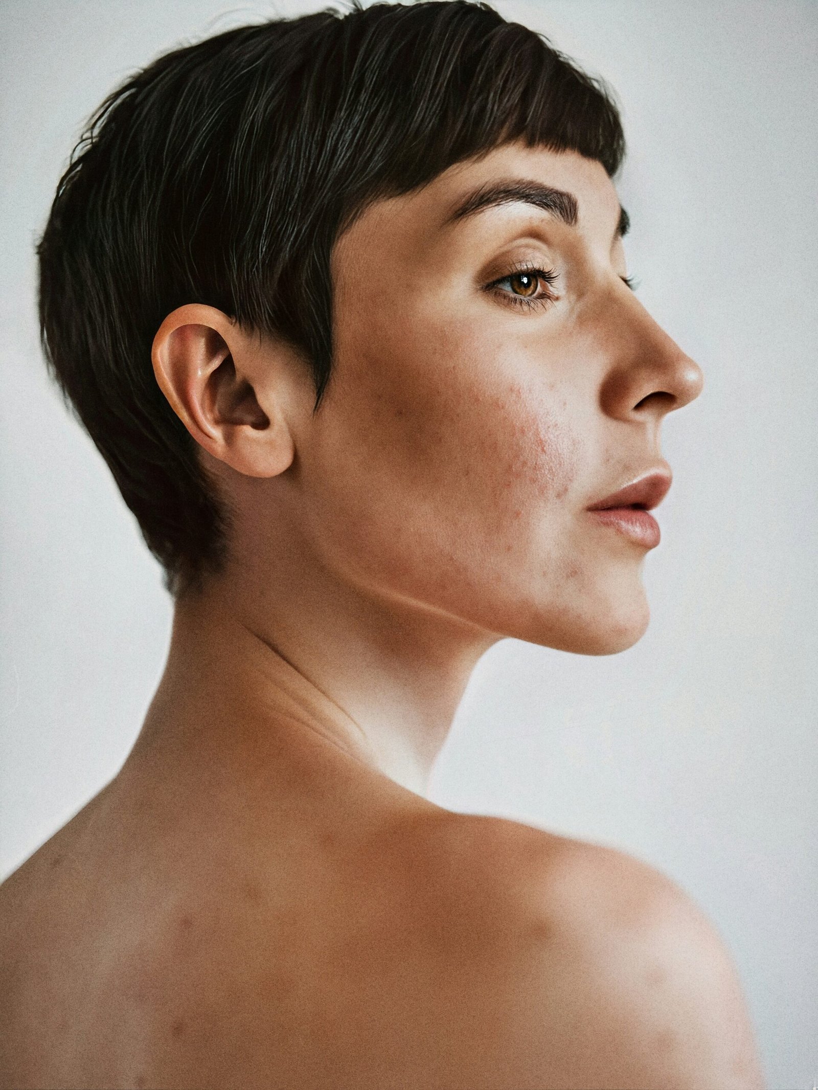 Ai generated portrait of model with short dark hair and bare shoulders