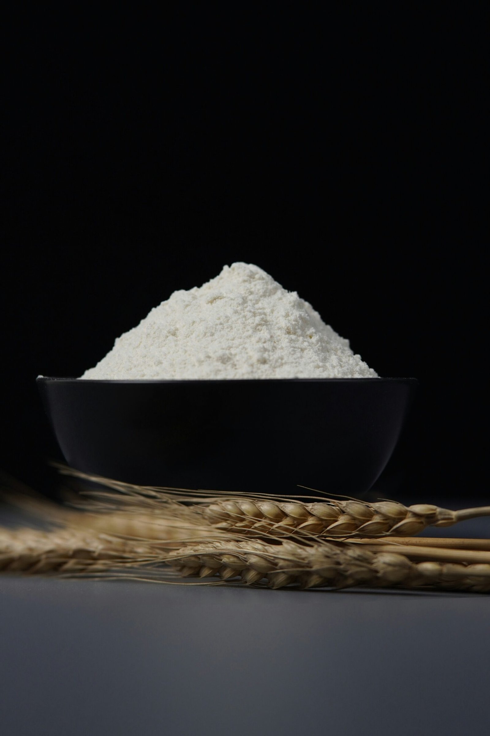 a bowl of flour sitting on top of a table